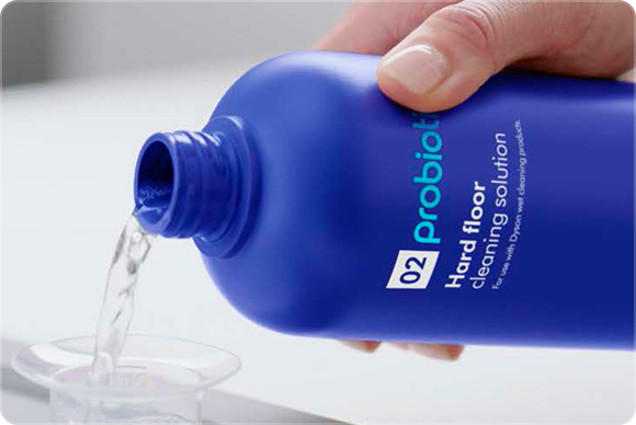 Dyson 02 Probiotic hard floor cleaning solution dispensed into a measuring cup.