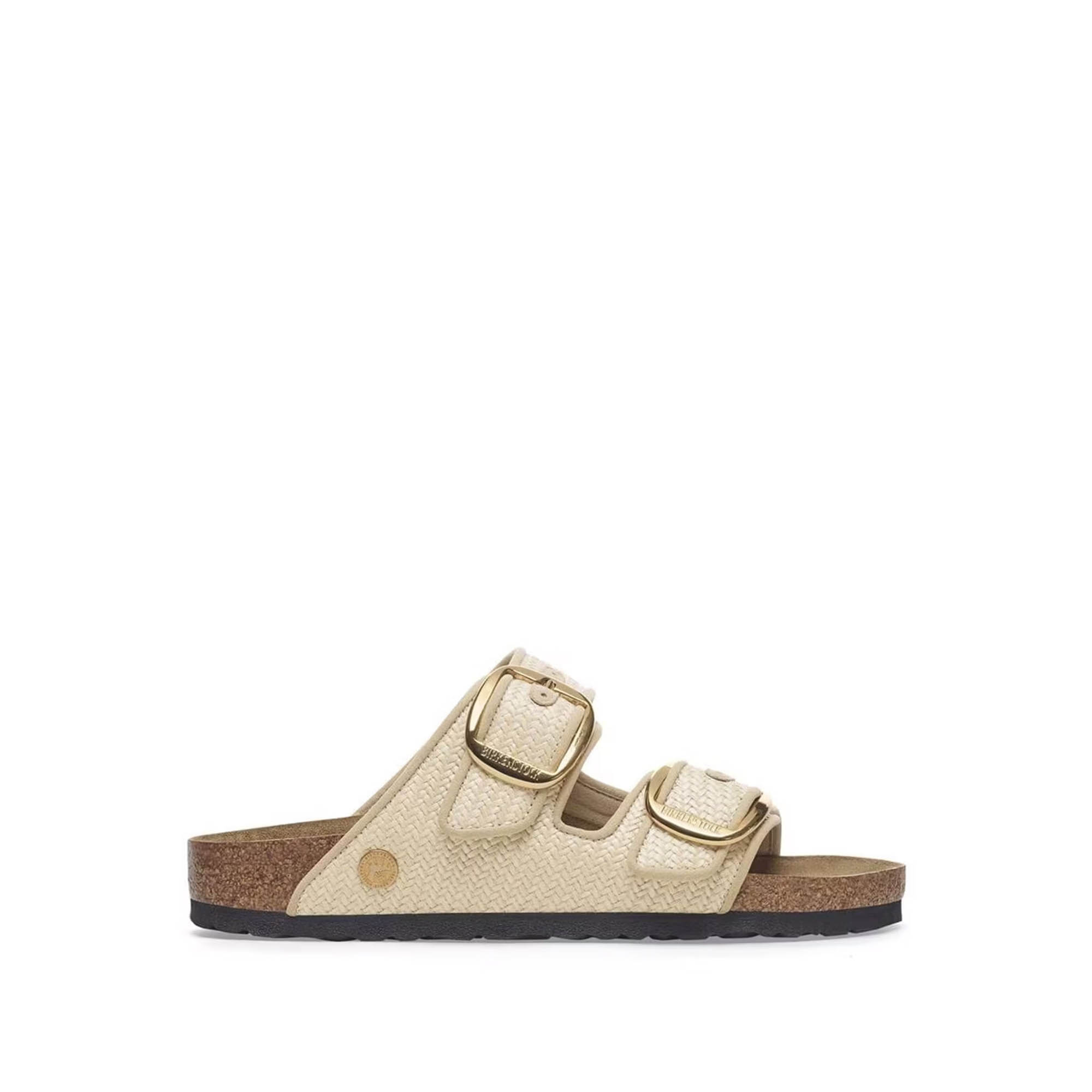 Beige woven double-strap slide sandal with cork footbed, gold buckles and black rubber sole