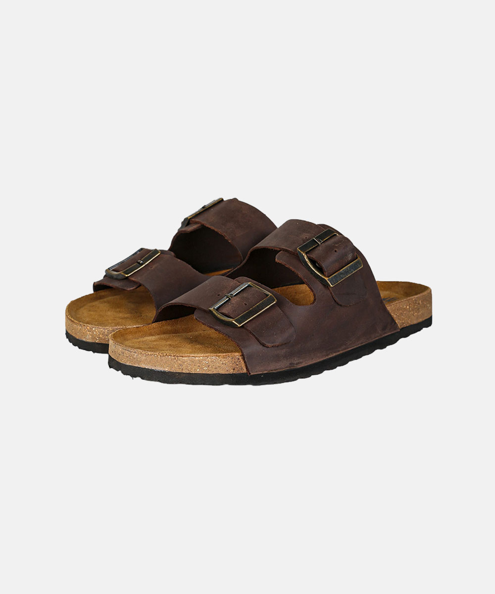 Brown leather double-strap cork footbed sandals with adjustable brass buckles on white background