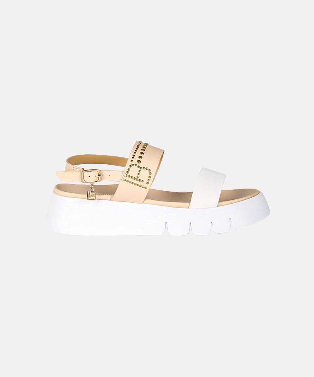Beige and white platform sandal with gold-studded strap, ankle buckle and thick white ridged sole