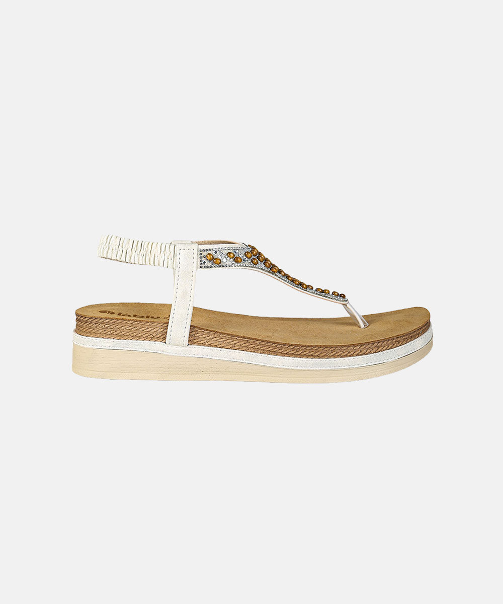 White women's platform thong sandal with elastic ankle strap, tan cushioned footbed and amber gemstone beaded T-strap embellishment