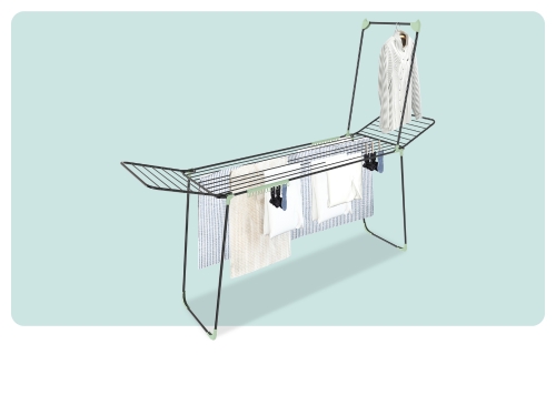 Freestanding folding clothes airer with multiple tiers, hanging shirts, towels and socks on a pale blue background