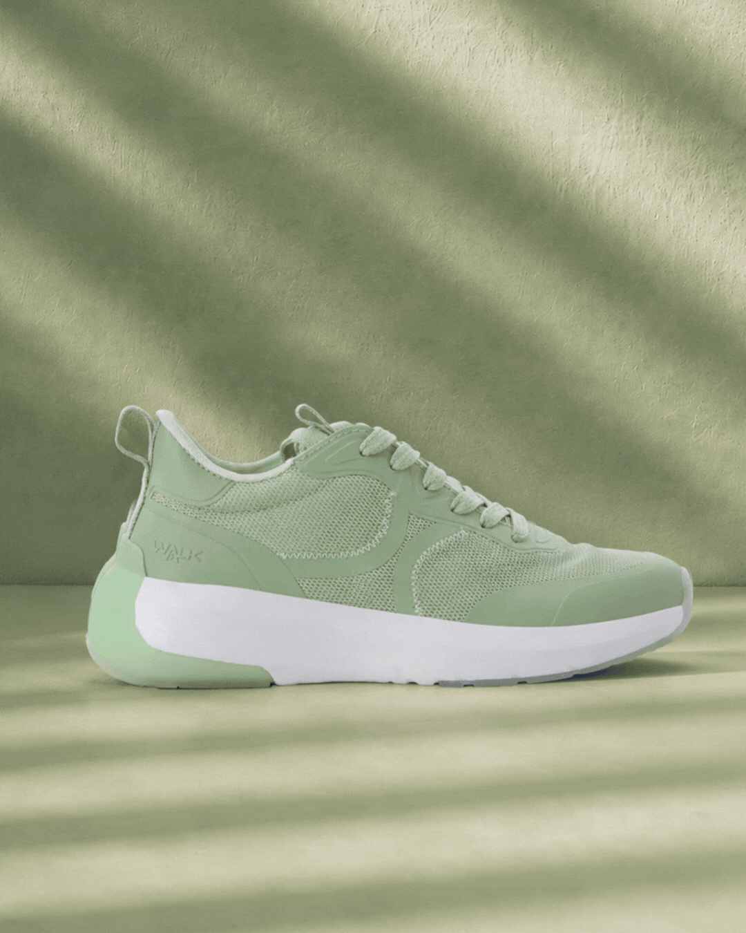 Mint green lace-up sneaker (left) and navy slip-on athletic shoe (right) with white soles on split green and blue background