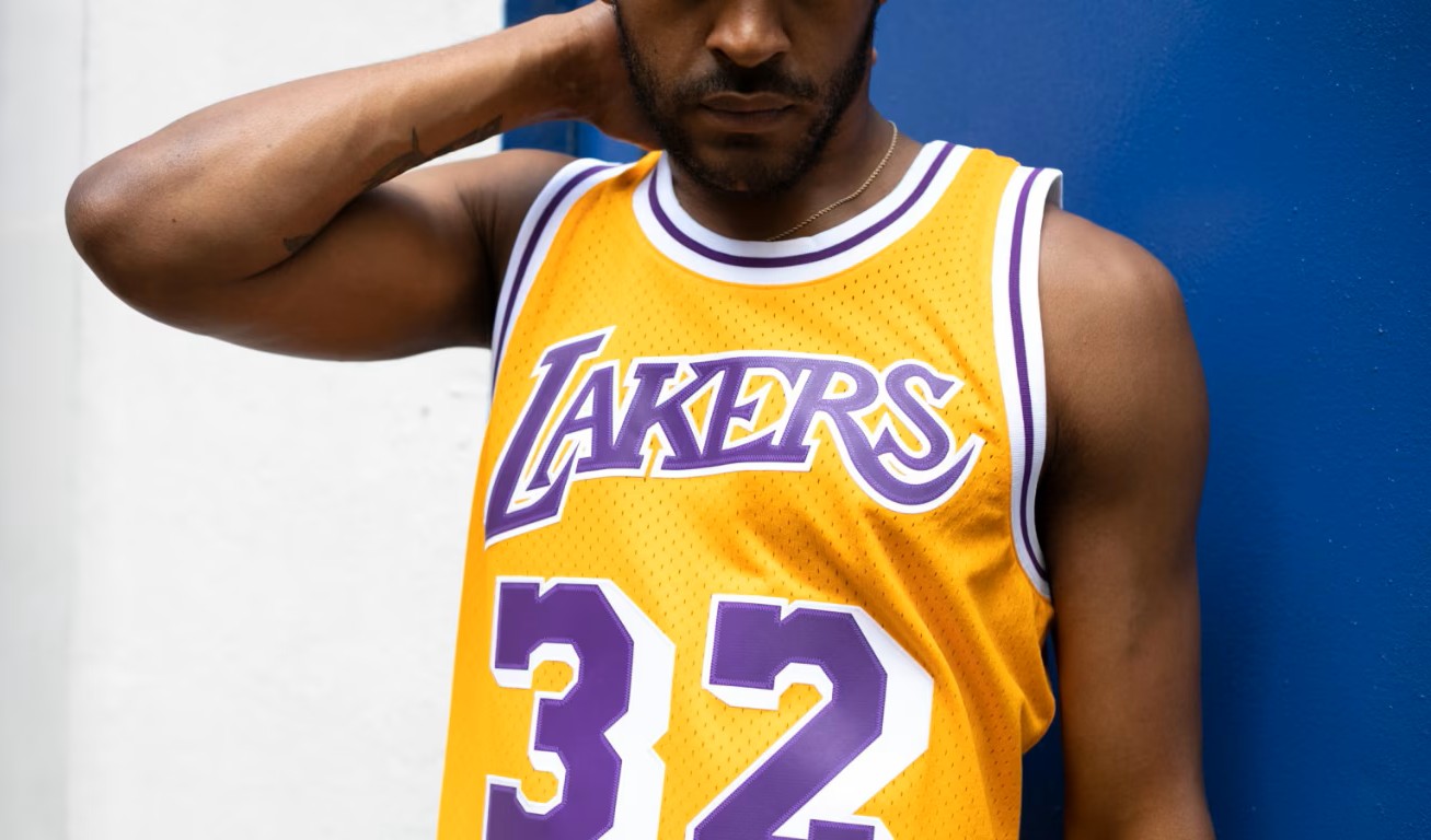 Model wearing Los Angeles Lakers Mitchell & Ness Swingman Jersey Magic Johnson 1984