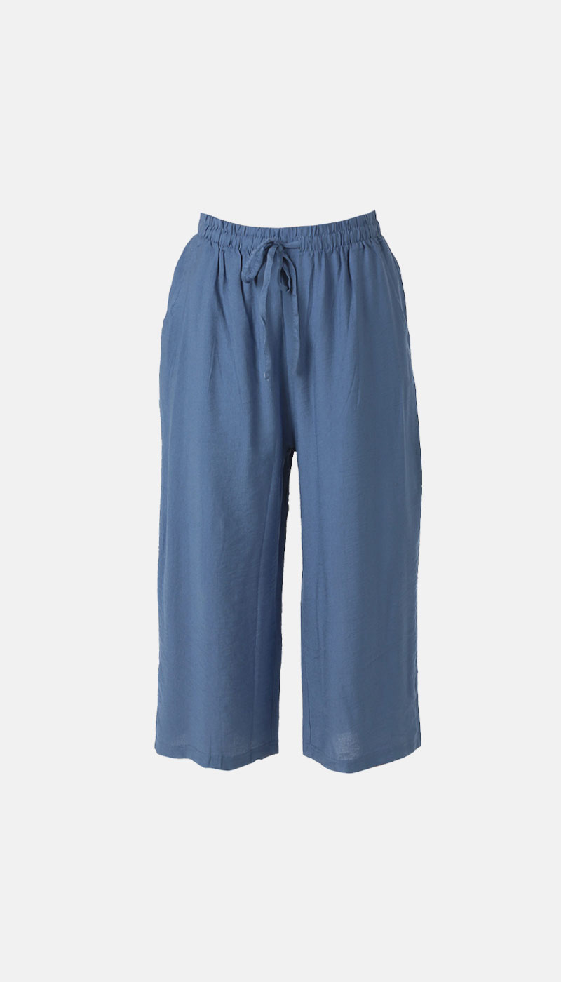 Blue cropped wide-leg linen trousers with elasticated waistband and drawstring, relaxed fit on plain white background