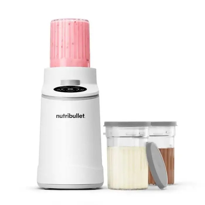 White Nutribullet personal blender with pink blending cup attached and two clear storage jars with lids holding vanilla and chocolate smoothies