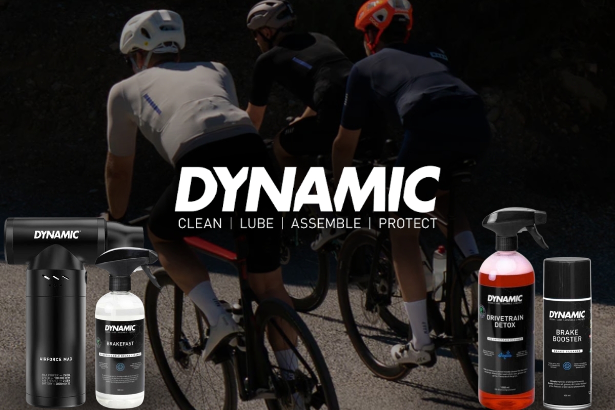 Cyclists riding on a sunlit road with DYNAMIC bike-care products (Airforce Max, Brakefast, Drivetrain Detox, Brake Booster) in foreground