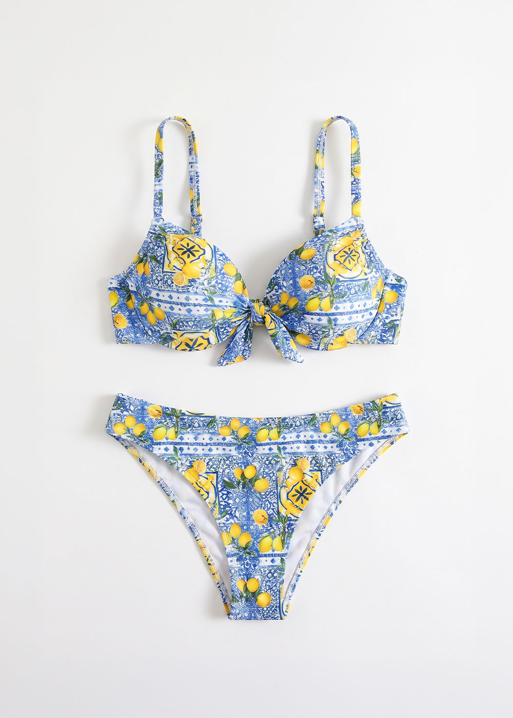 Blue and white patterned bikini with yellow lemon print, padded tie-front bra with adjustable straps and matching briefs on white background
