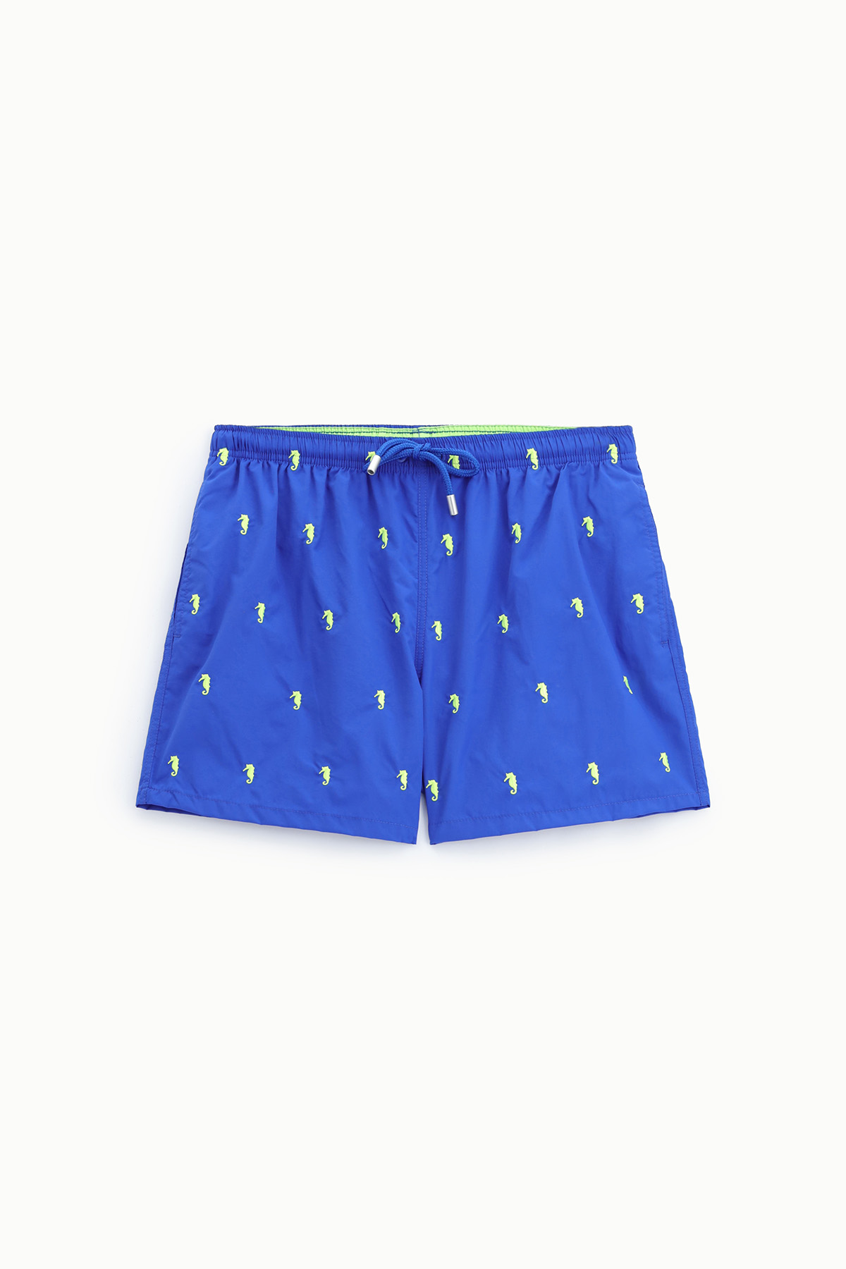 Blue men's swim shorts with neon-green seahorse print and drawstring waist, flat-lay on white background