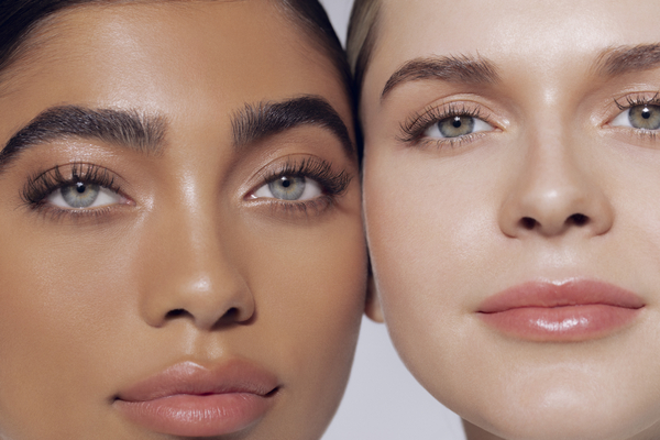 an image of two women with different makeup looks at the camera