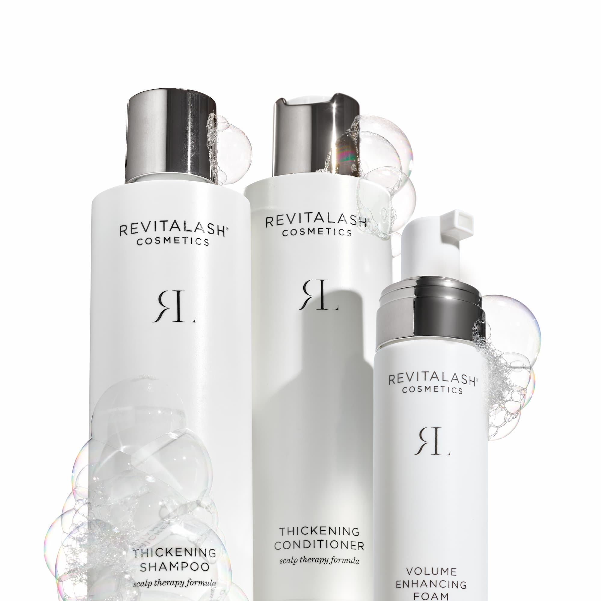 an image of a group of three bottles of hair products