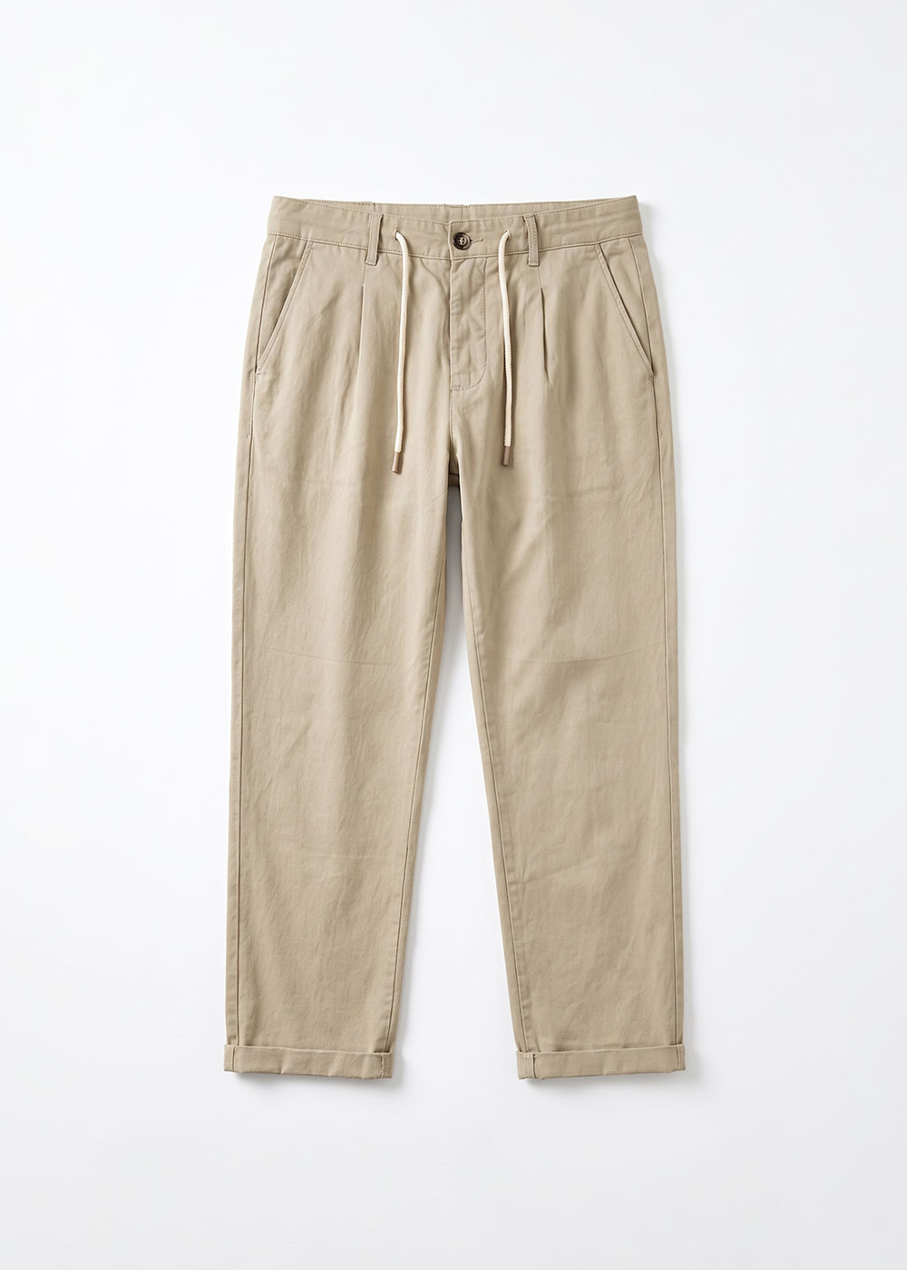Beige cuffed cotton chino trousers with drawstring waist and side pockets, flat-lay on white background