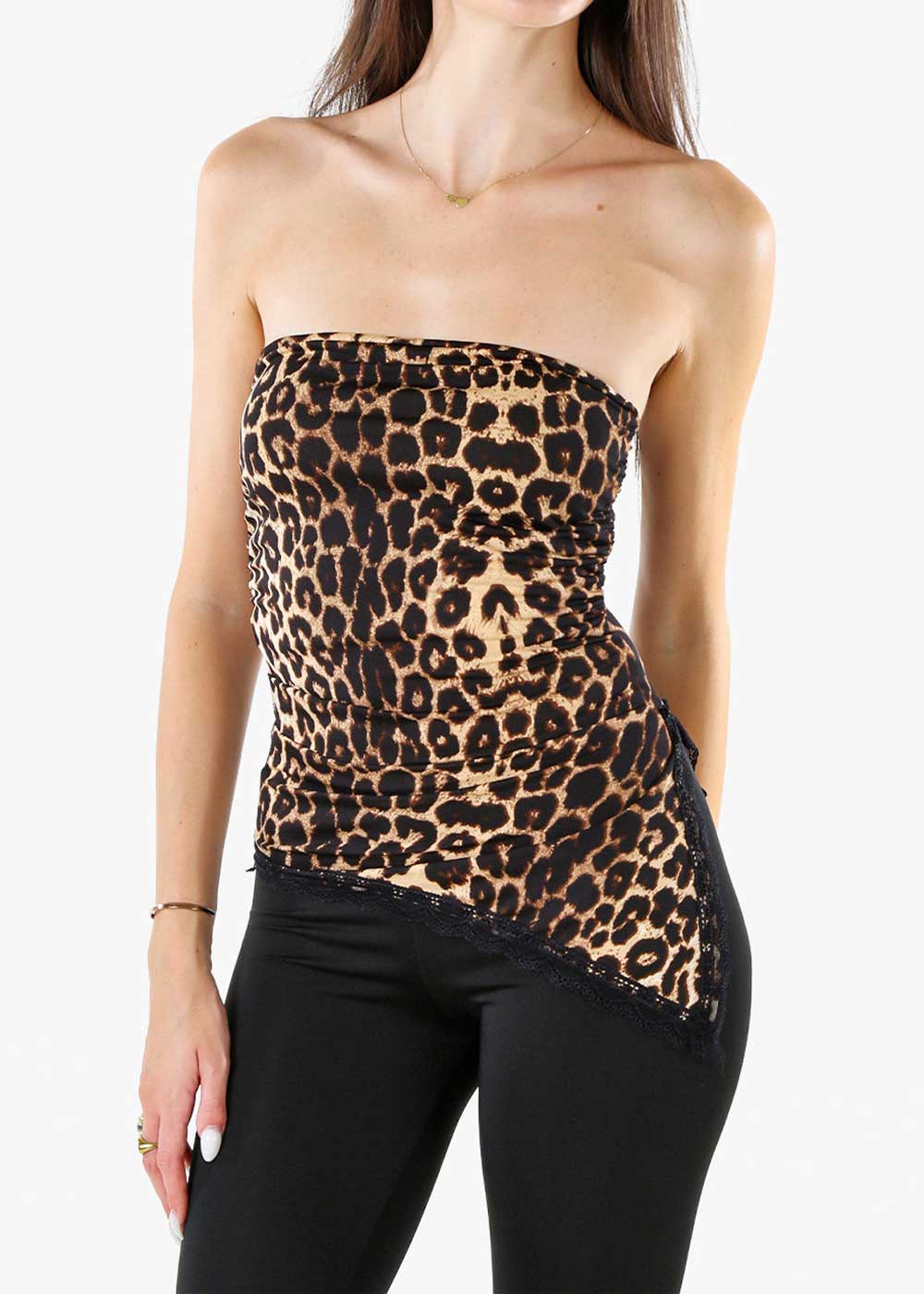Female model wearing a leopard-print strapless asymmetric top with lace trim paired with black trousers