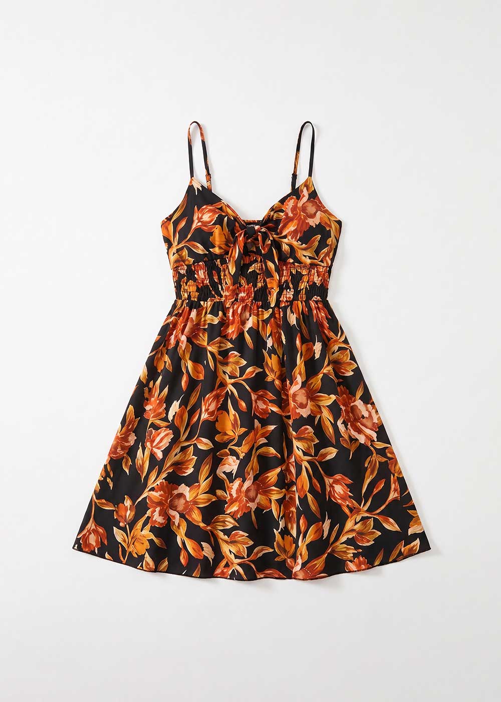 Black sundress with orange and yellow floral print, smocked waist and front bow tie, thin spaghetti straps, knee-length A-line