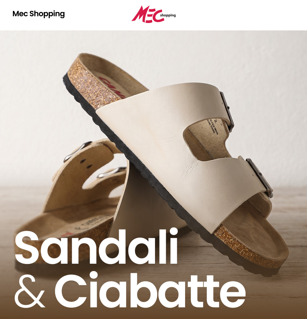 Beige cork-footbed double-strap sandals with metal buckles on a wooden surface, MEC Shopping logo and "Sandali & Ciabatte" text