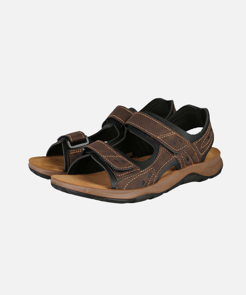 Pair of brown leather men's adjustable-strap sandals with cushioned tan footbed and black rubber sole, isolated on white