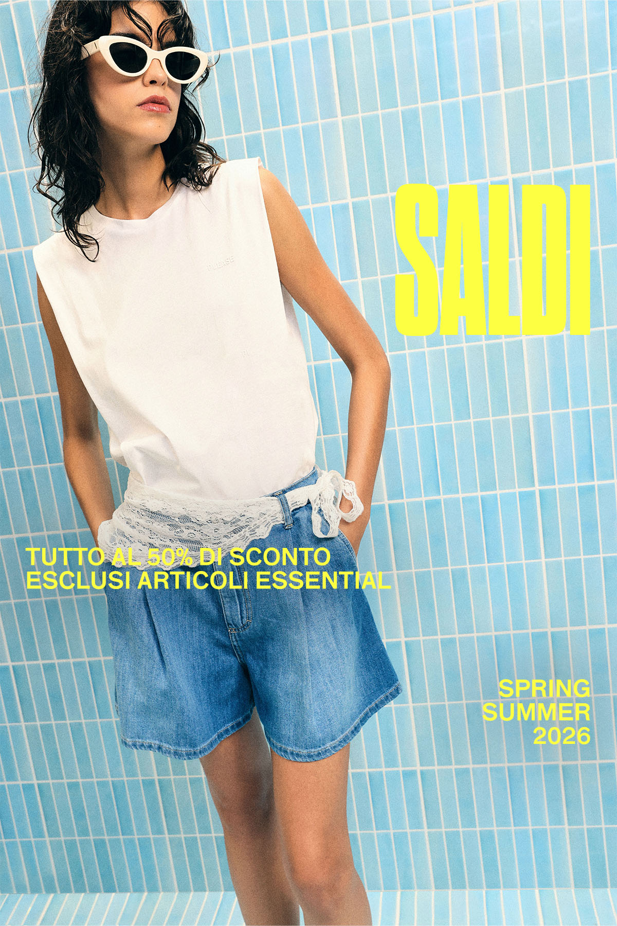 Fashion model wearing white sleeveless top, denim shorts and white cat-eye sunglasses against blue tiled wall, 'SALDI' sale ad