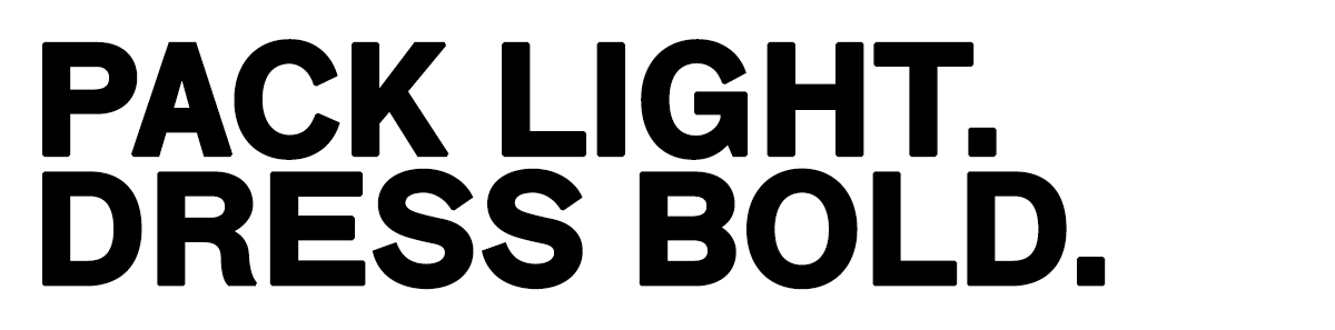 Black bold text on white background reading “PACK LIGHT. DRESS BOLD.” for travel and fashion slogan
