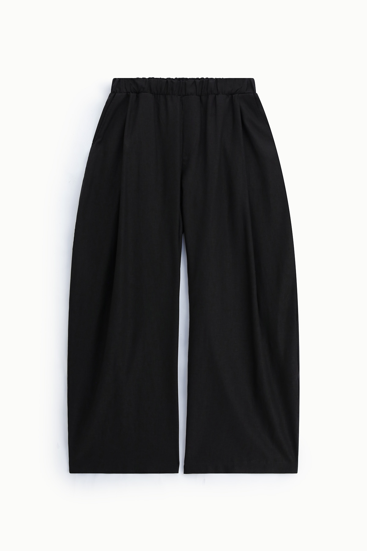 Black wide-leg trousers with elasticated waistband and front pleats, flat-lay on white background