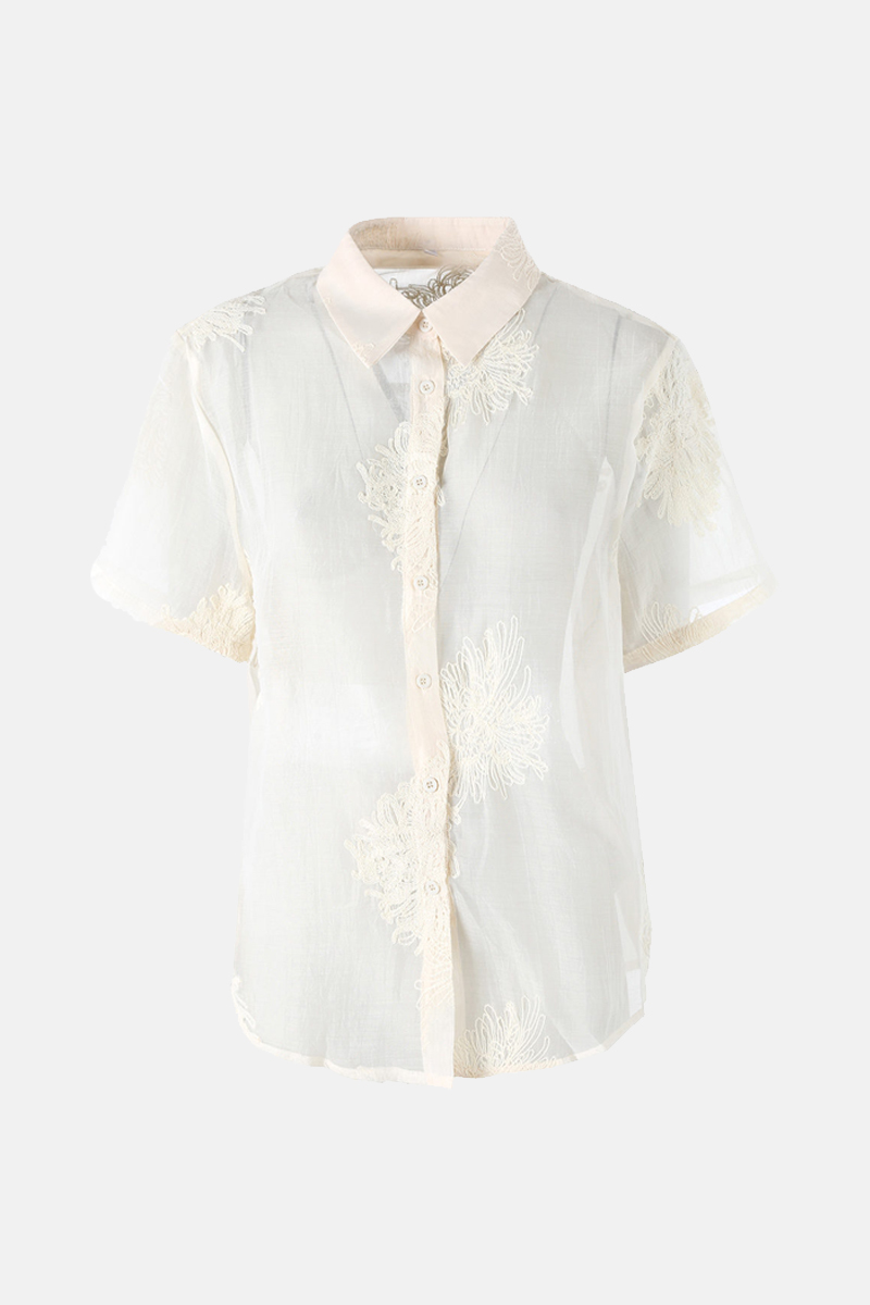 Sheer white short-sleeve blouse with cream floral lace embroidery, pale beige collar and button-front women's top