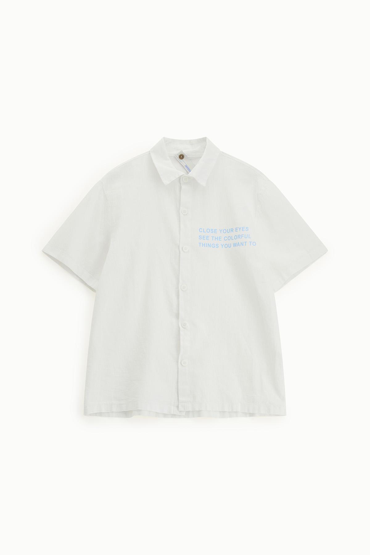 White short-sleeve button-up shirt with collar and small blue printed slogan on left chest reading "CLOSE YOUR EYES"