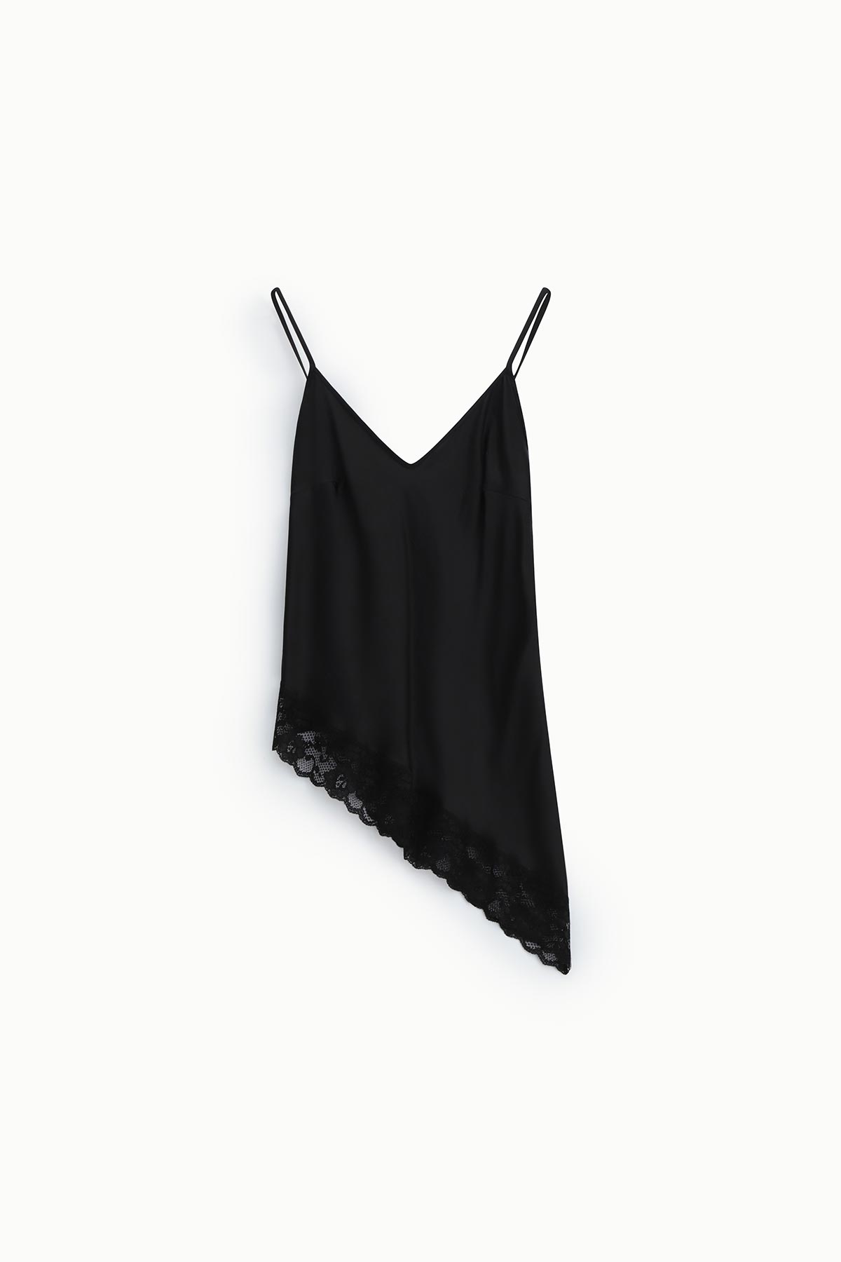 Black silk-look asymmetrical slip dress with thin spaghetti straps and scalloped lace hem on a white background