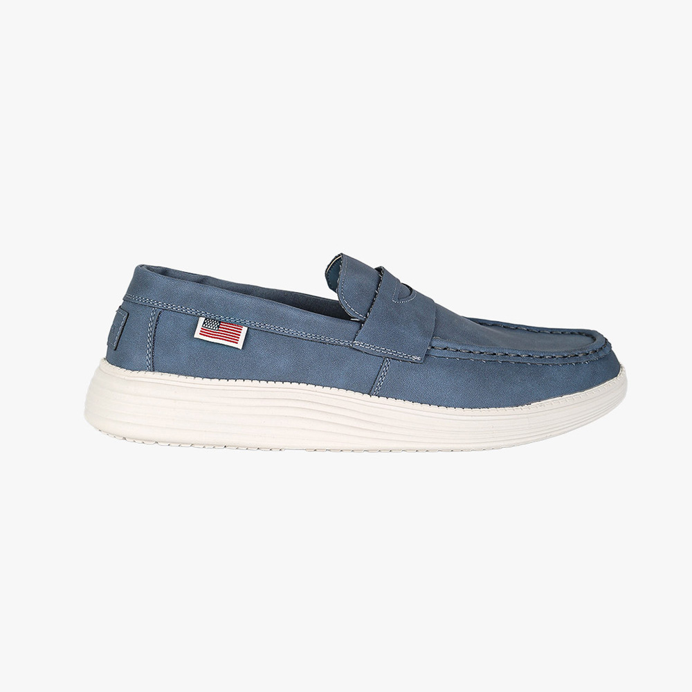 Blue leather slip-on loafer with white rubber sole and small American flag tag, side profile on white background