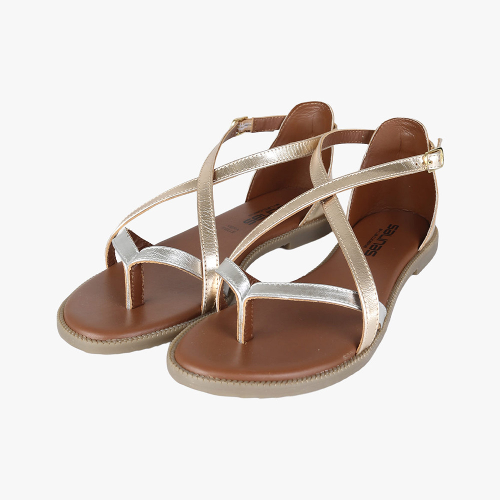 Pair of women's metallic rose-gold toe-post sandals with ankle straps and brown footbeds on a white background