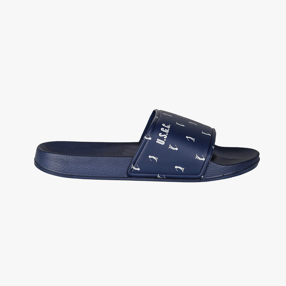 Navy blue slide sandal with small white anchor print on the strap and cushioned footbed, casual pool or beach slipper