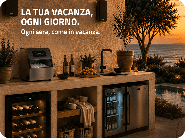 Outdoor sunset kitchen with built‑in wine fridges, mini fridge and ice maker on a stone countertop with bottles, fruit and sea view