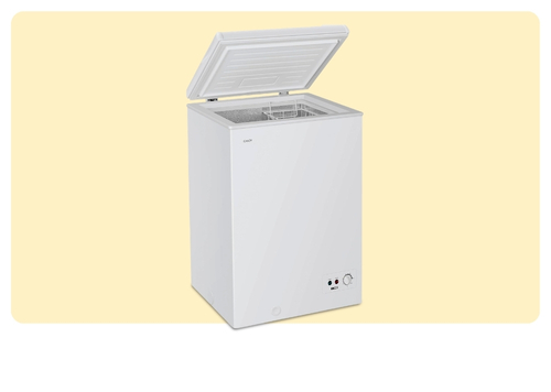 White compact chest freezer with open lid and internal wire basket, front control knob and indicator lights on beige background