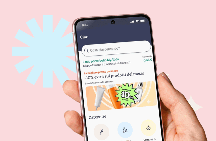 Two hands holding smartphones displaying a shopping app with category icons and a 10% off promo banner on a pastel pink background