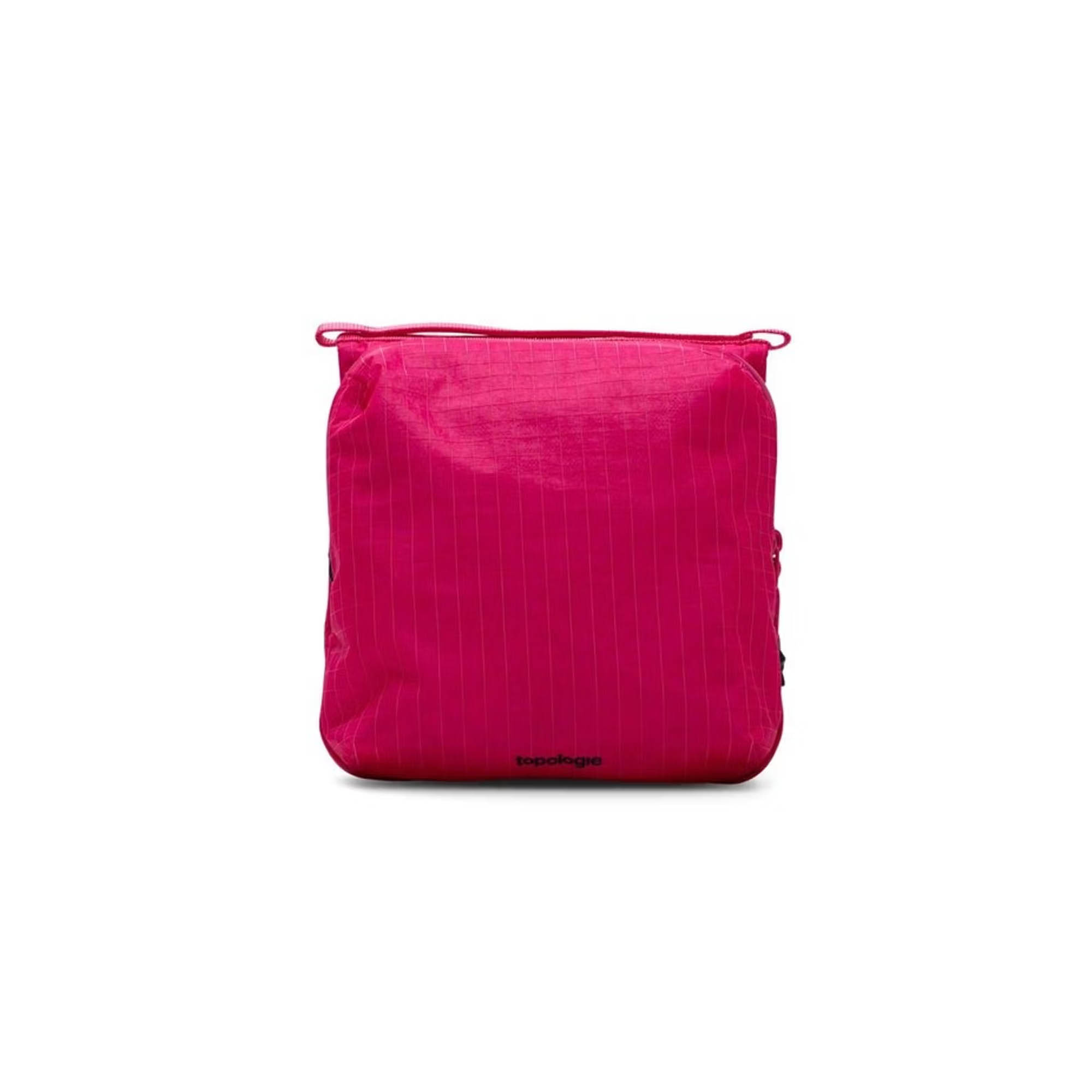 Bright fuchsia square packing cube with thin vertical pinstripes and top zip closure, flat on white background