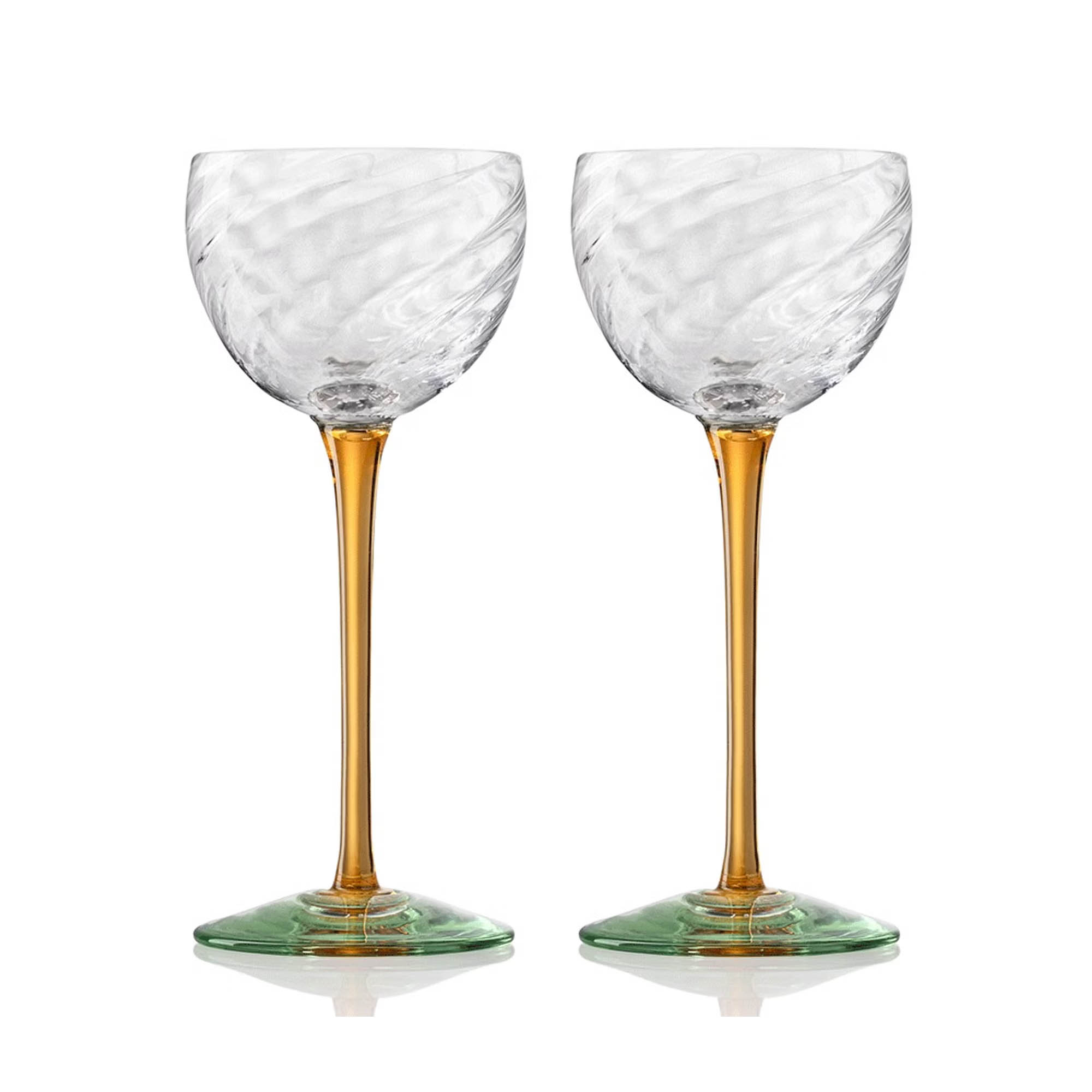 Pair of tall cocktail glasses with swirled clear bowls, amber stems and green bases on white background