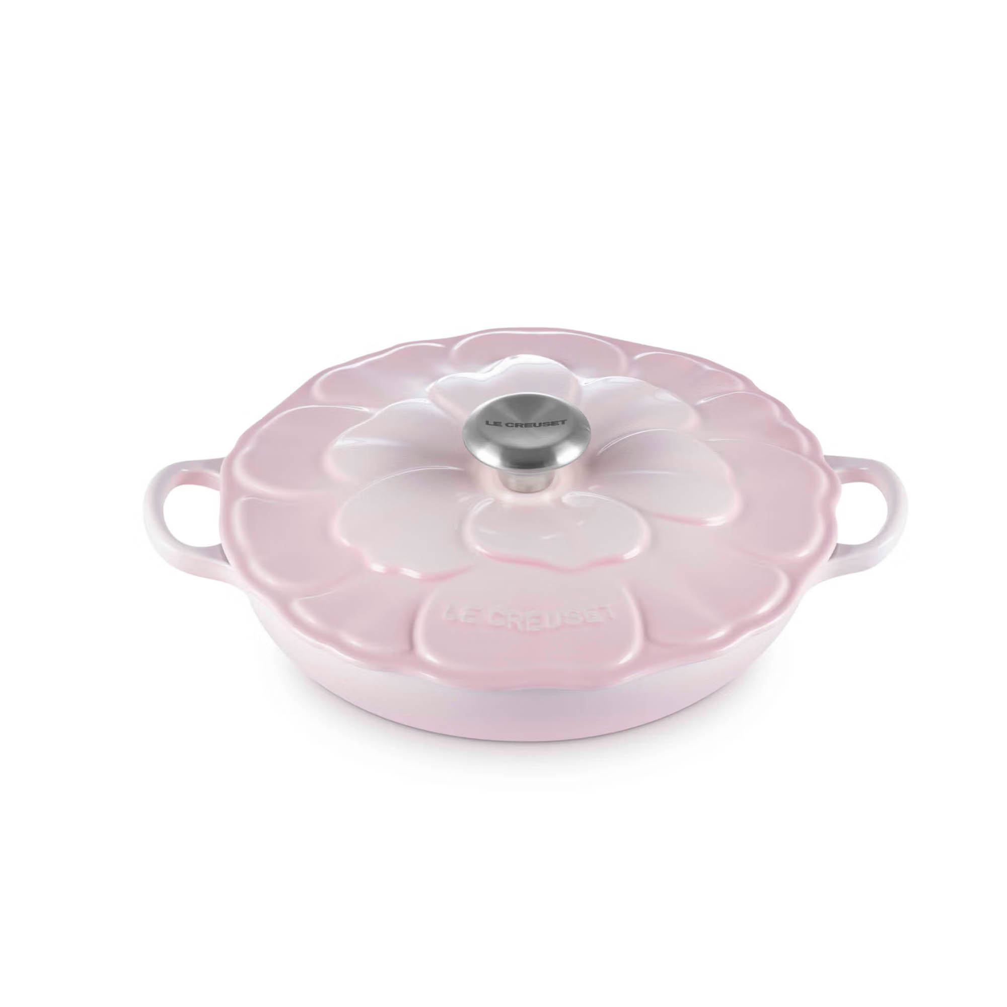 Pink Le Creuset flower-shaped cast iron casserole with lid and stainless knob, twin side handles on white background