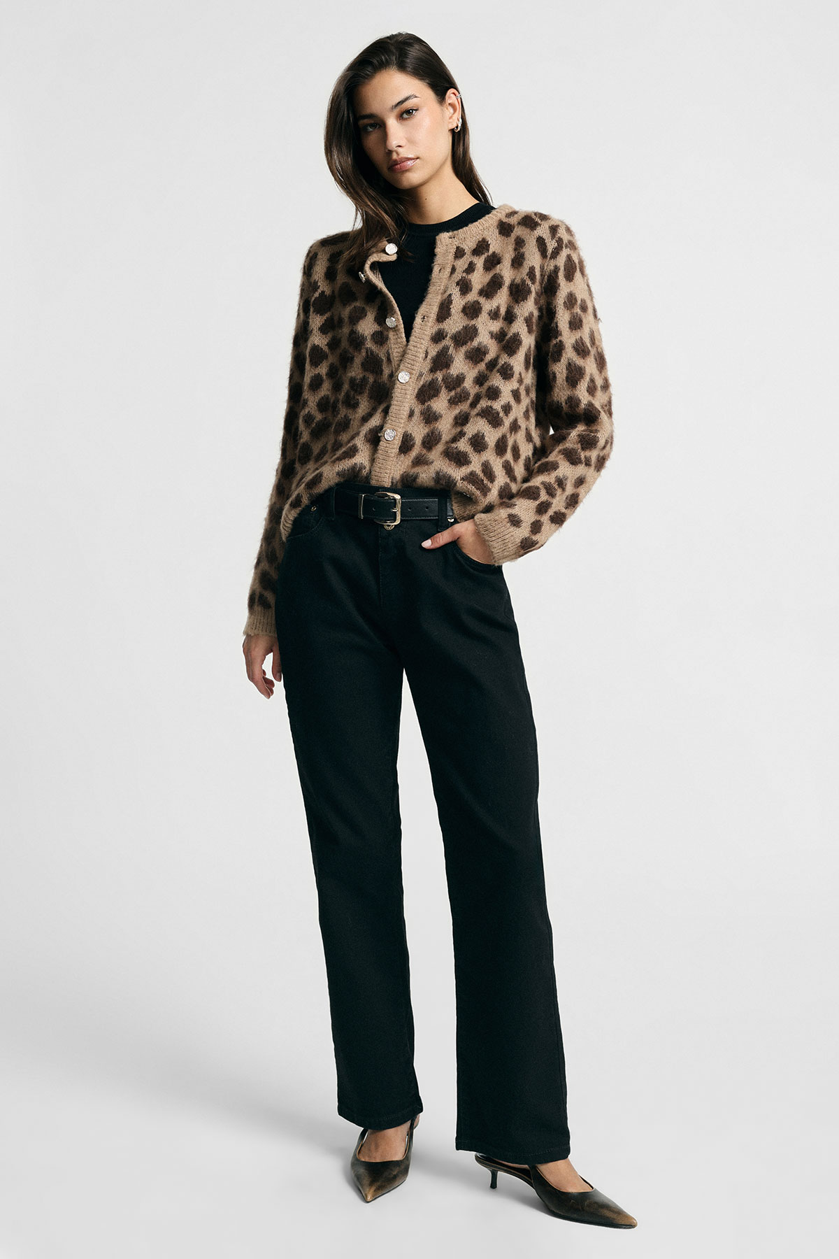 Model wearing brown leopard-print fuzzy cardigan over black top, high-waist black trousers and heels on white background