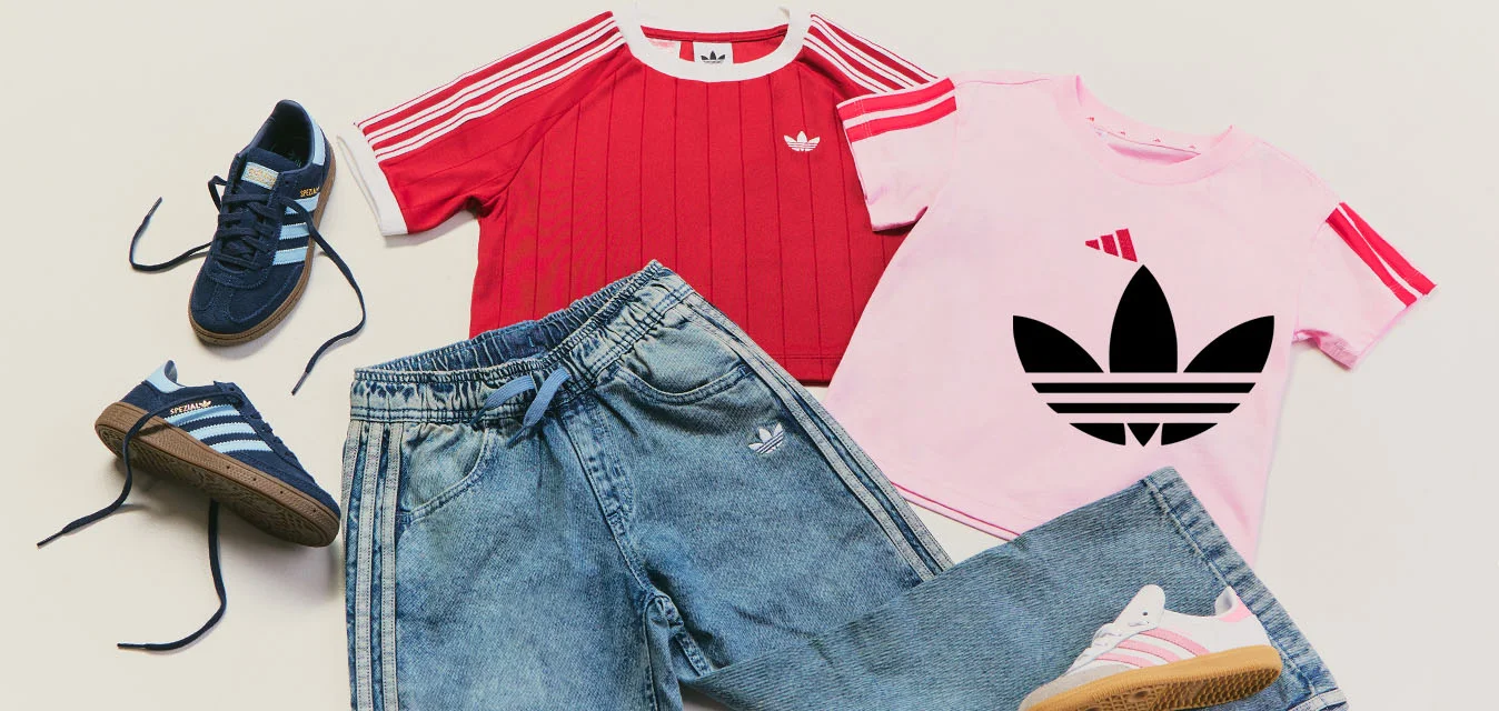 Due paia di scarpe da ginnastica Adidas, blu e bianche con dettagli rosa, insieme a due magliette a maniche corte, una rossa e una rosa, e un paio di jeans Adidas blu.