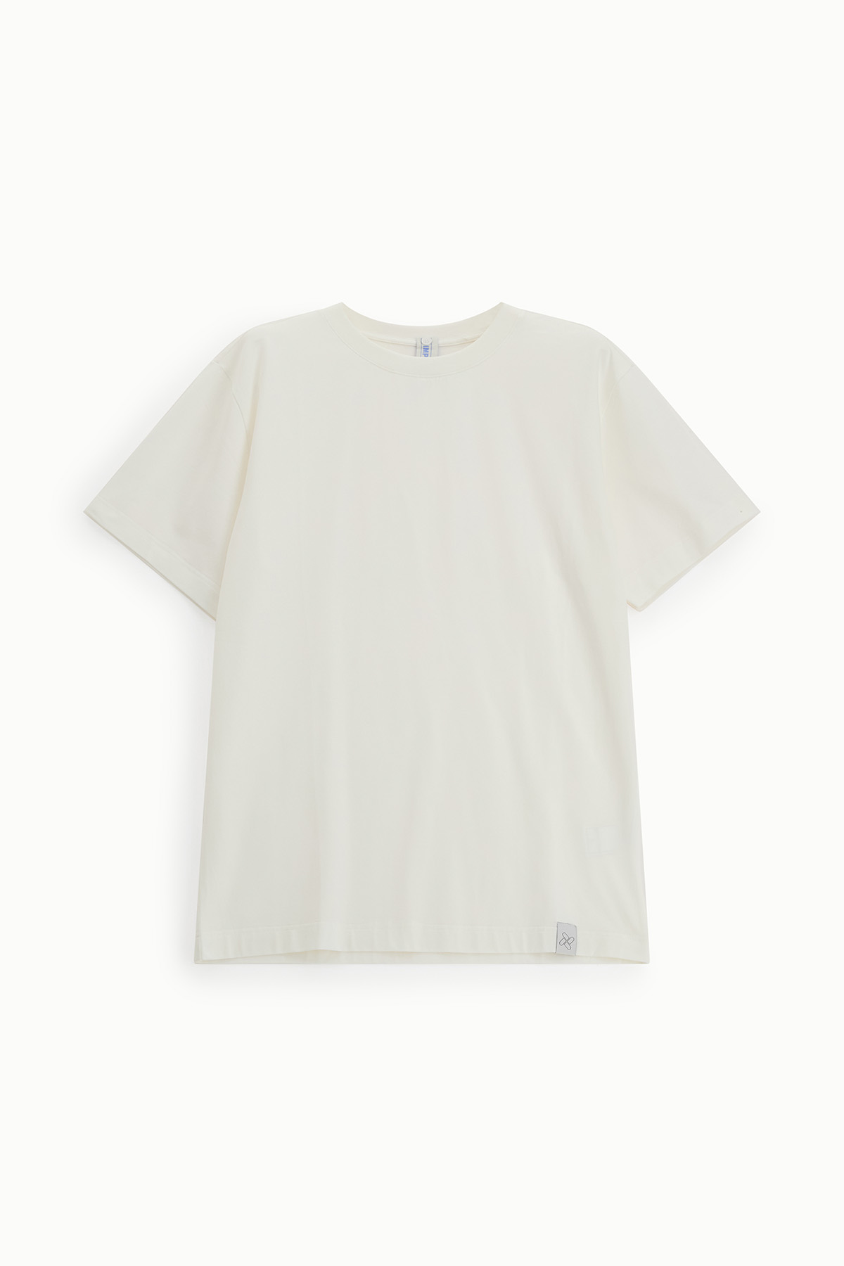 Plain cream crew-neck short-sleeve T-shirt laid flat on white background with small brand tag at hem