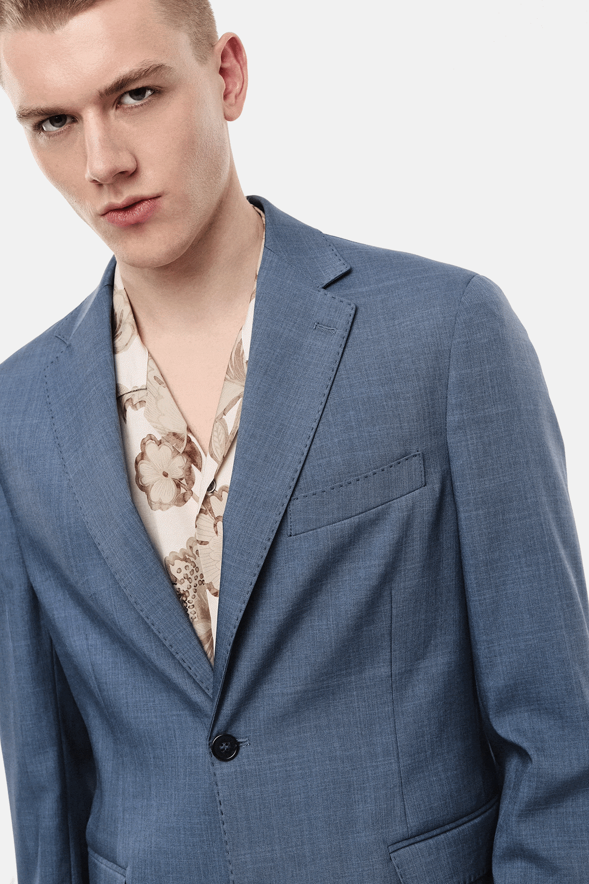 Collage of male models in tailored blue and beige linen suits with patterned shirts, showing full-length and close-up shots on a white background
