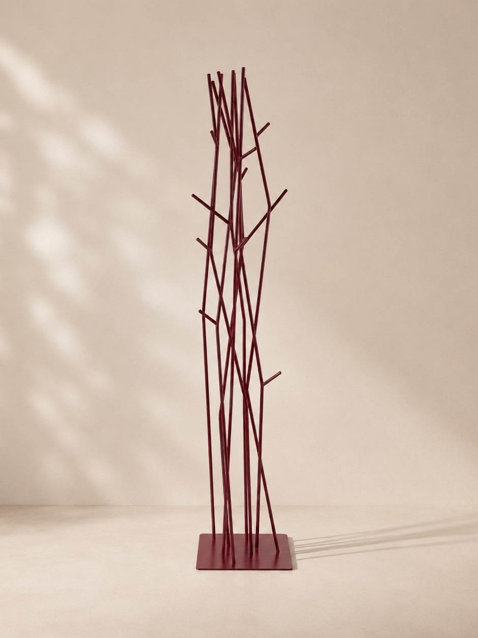 Burgundy metal freestanding coat rack with thin twig-like branches on square base, minimalist modern hallway furniture