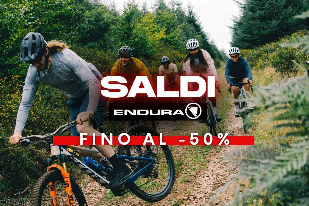 Four mountain bikers in helmets riding a forest trail, with red promotional overlay reading 'Sale Endura up to -50%'.
