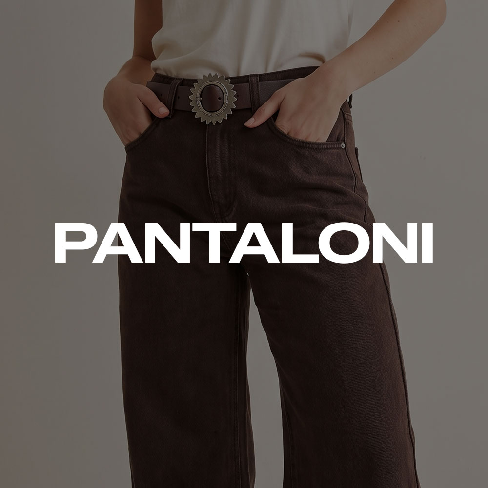 Waist-down view of a person wearing dark brown high‑waist wide‑leg trousers with belt and hands in pockets, white top visible
