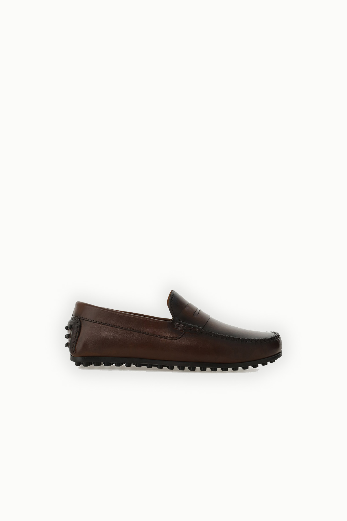 Brown leather men's driving loafer, side view with pebble rubber sole and stitched apron on white background