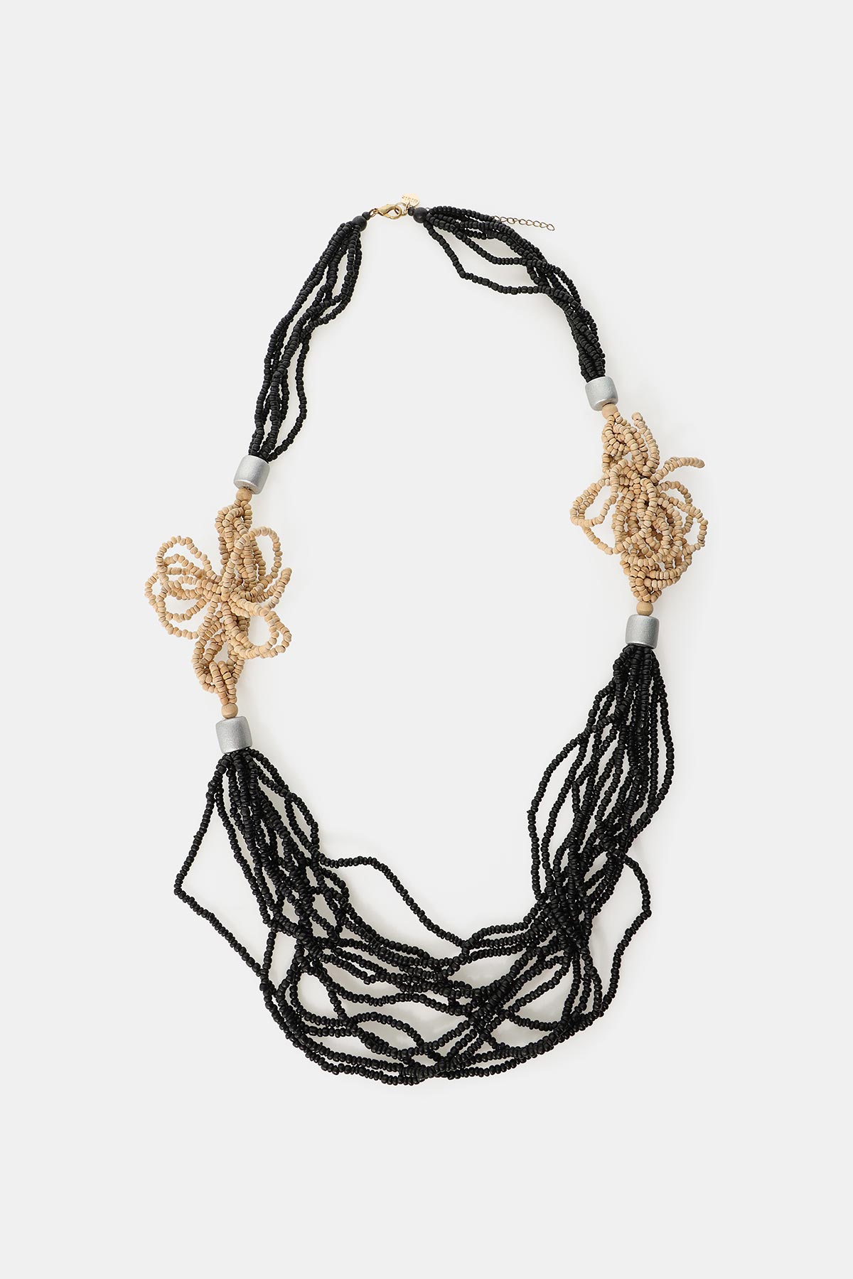 Multi-strand black beaded necklace with beige knotted decorative clusters, silver spacer beads and gold clasp on white background