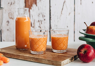 Homemade carrot and apple juice with cinnamon
