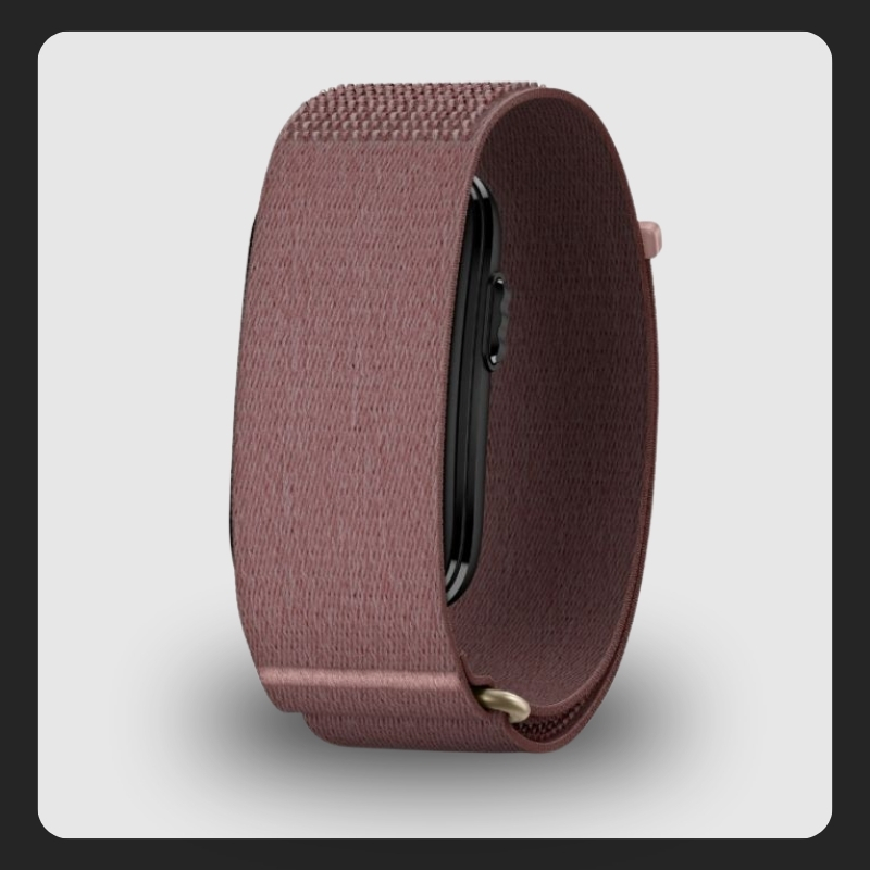 Rose-pink woven nylon loop smartwatch strap wrapped around a watch case, showing fabric texture and metal connector
