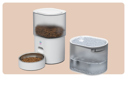 Modern white automatic pet feeder dispensing dry kibble next to a clear pet water fountain, compact design