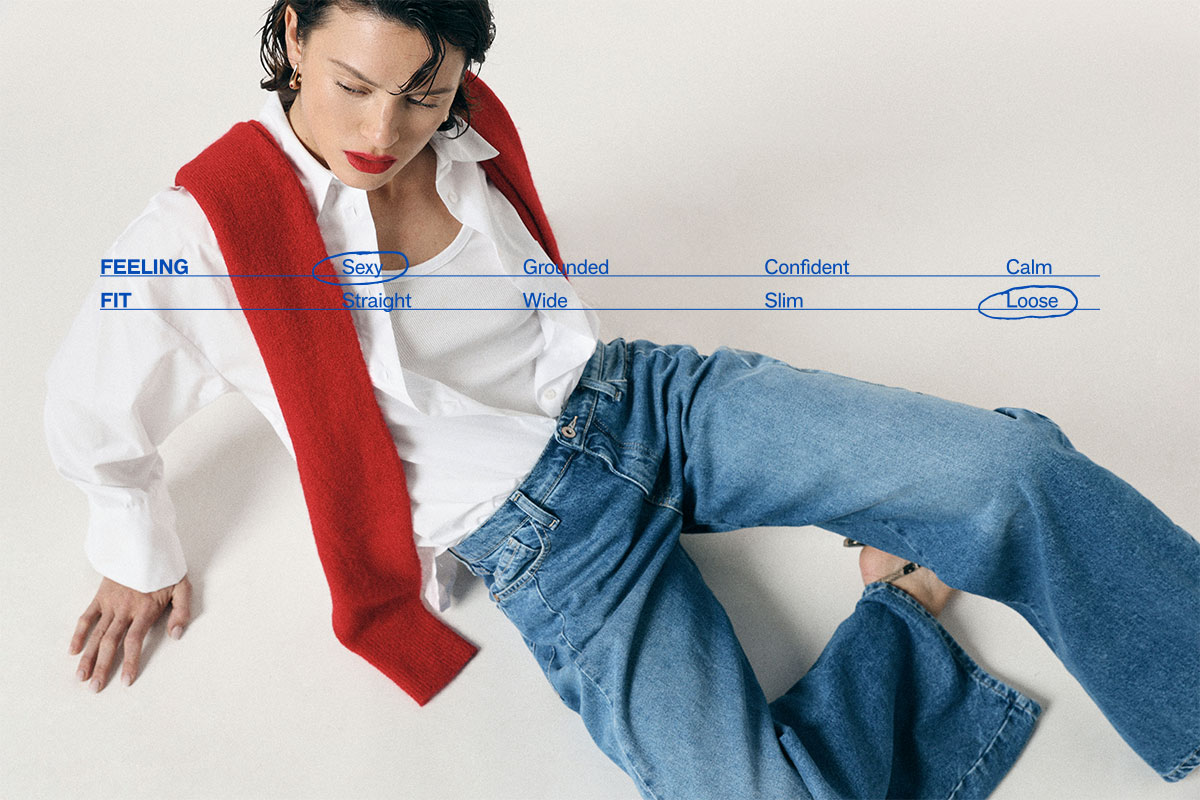 Reclining woman in white shirt with red sweater draped over shoulders and loose blue jeans; blue overlay graphic highlights “Sexy” and “Loose”.