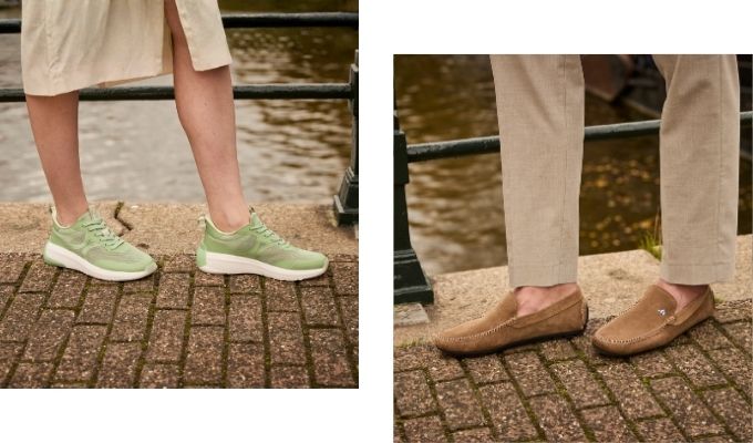 Two pairs of shoes by a riverside: green casual sneakers on left and tan suede loafers on right on brick pavement