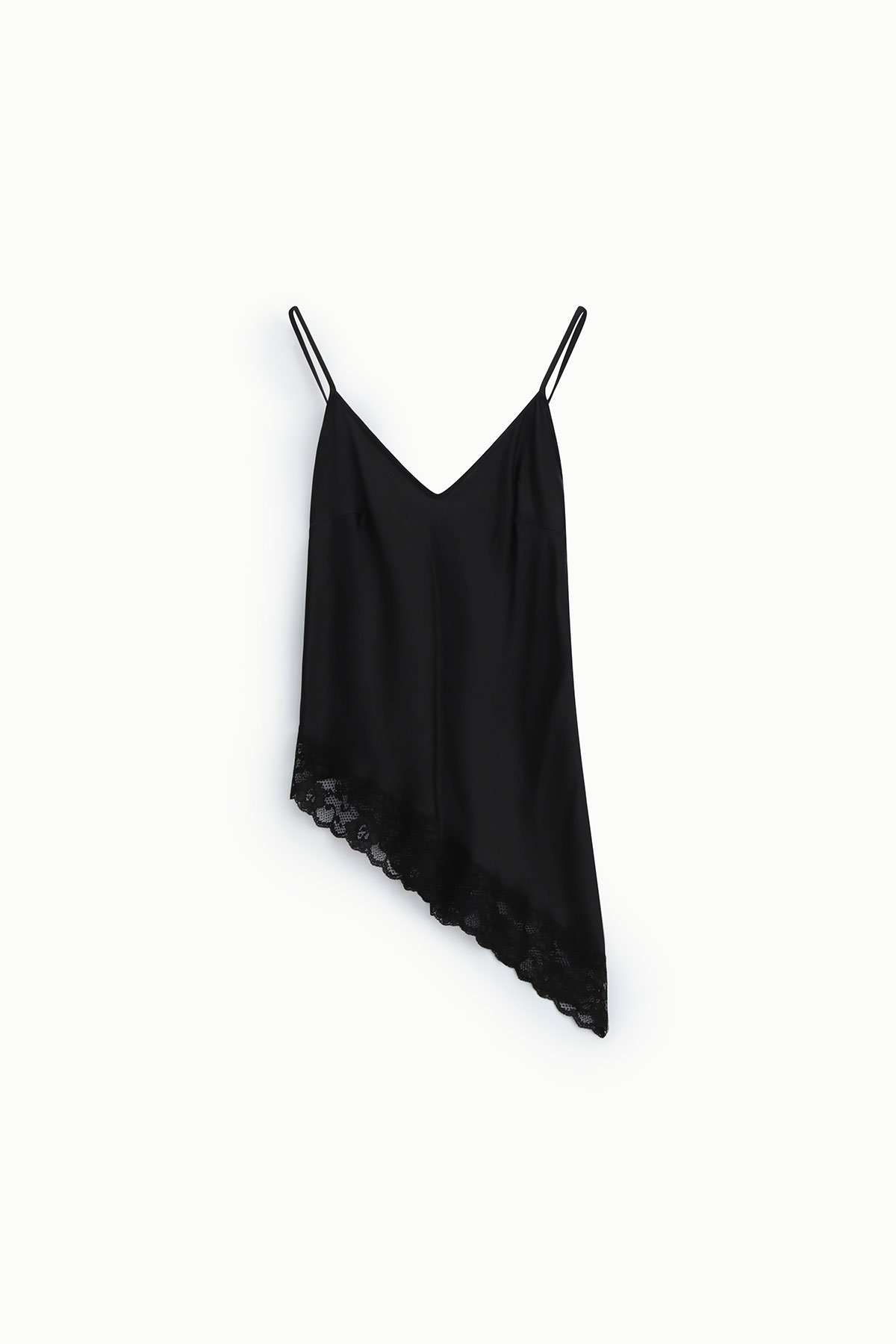 Black silk asymmetrical slip dress with V-neck, thin spaghetti straps and lace-trimmed angled hem on white background